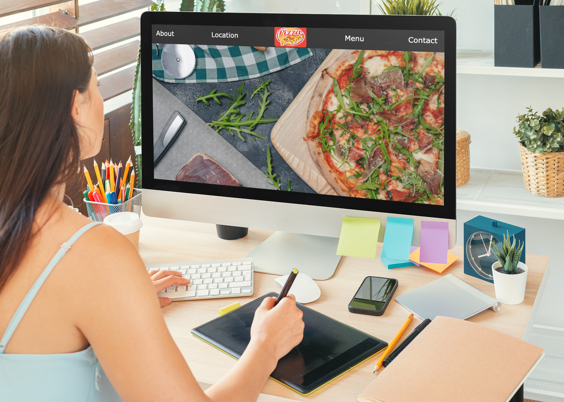 woman looking at computer with Neighbors Pizza on it